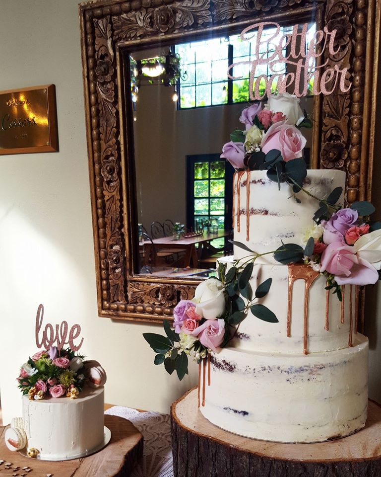 3 tier white wedding cake with fresh flowers