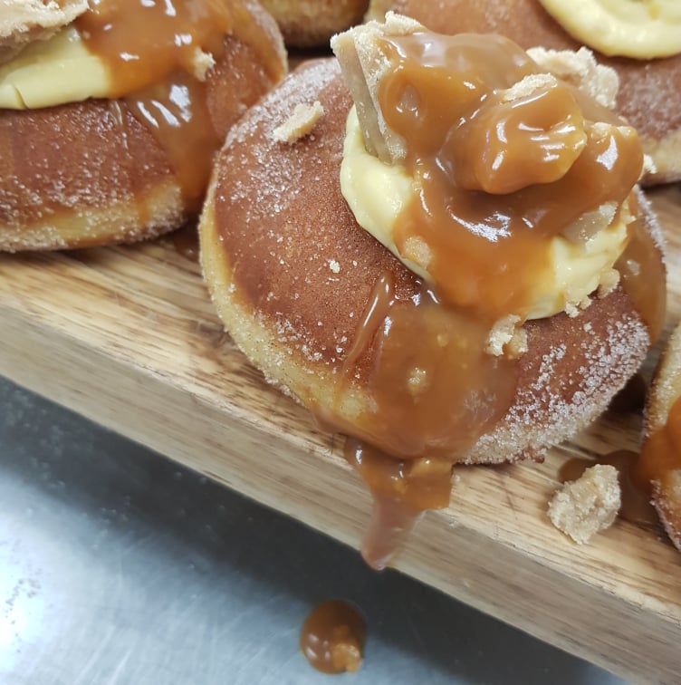 20th August Custard Filled Donut, Topped With Home Made Fudge And Dripping In Caramel Sauce